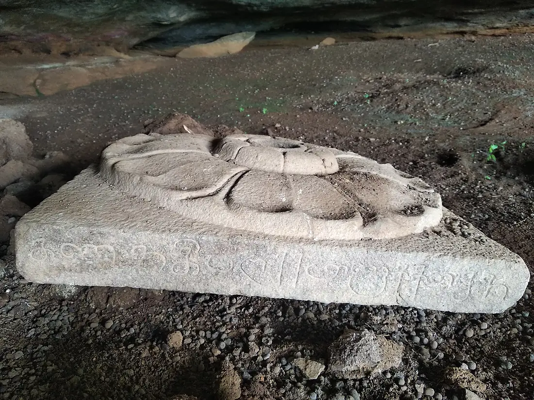 Stone carving with inscription Armamalai Caves