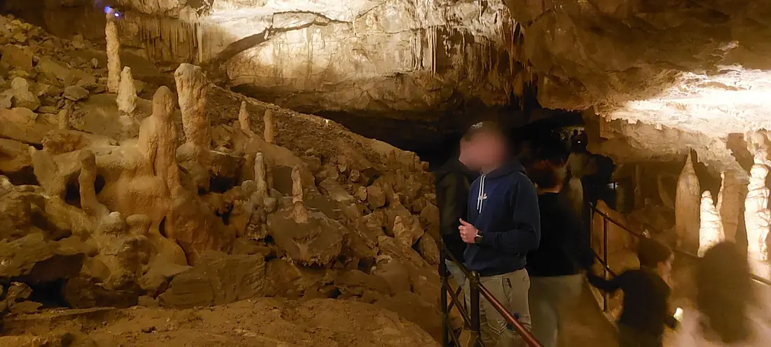 Visitors inside Postojna Cave among stalactites and stalagmites - Postojna, Slovenia